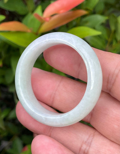 Handcrafted genuine Grade A Burmese jadeite infant bangle showcasing a translucent bright green appearance