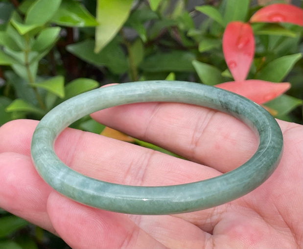 Handcrafted genuine Grade A Burmese jadeite slim stackable bracelet showcasing a translucent elegant appearance