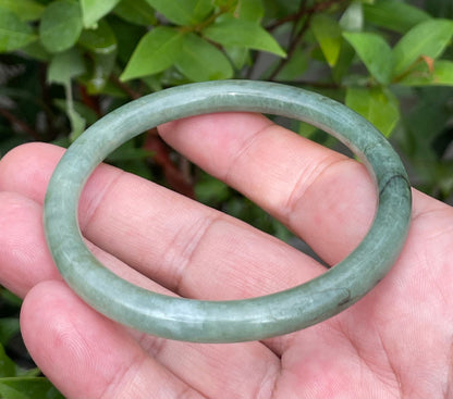 Handcrafted genuine Grade A Burmese jadeite slim stackable bracelet showcasing a translucent elegant appearance
