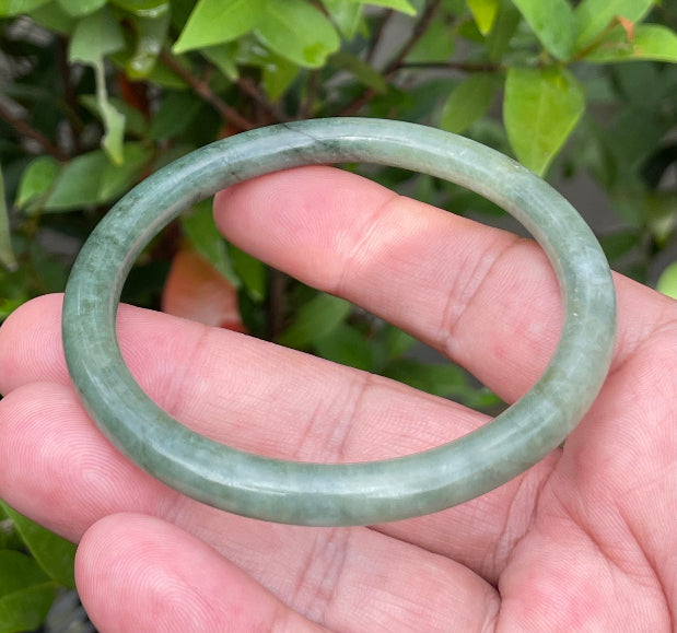 Handcrafted genuine Grade A Burmese jadeite slim stackable bracelet showcasing a translucent elegant appearance