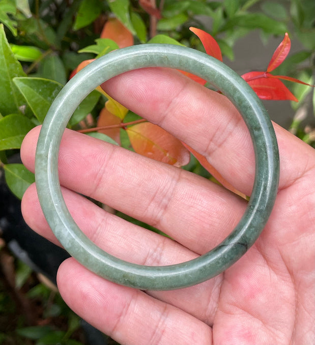 Handcrafted genuine Grade A Burmese jadeite slim stackable bracelet showcasing a translucent elegant appearance