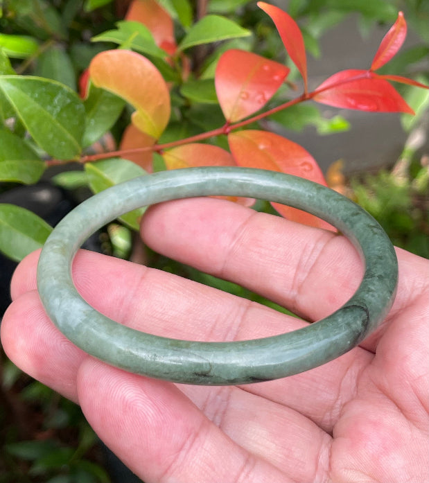 Handcrafted genuine Grade A Burmese jadeite slim stackable bracelet showcasing a translucent elegant appearance