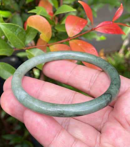 Handcrafted genuine Grade A Burmese jadeite slim stackable bracelet showcasing a translucent elegant appearance