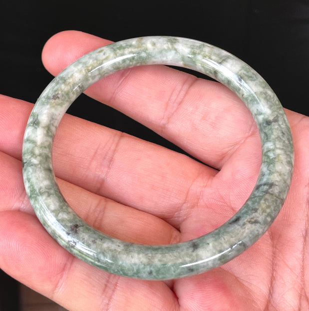 Handcrafted genuine Grade A Burmese jadeite bracelet showcasing a beautiful vibrant green and white appearance