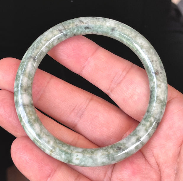 Handcrafted genuine Grade A Burmese jadeite bracelet showcasing a beautiful vibrant green and white appearance