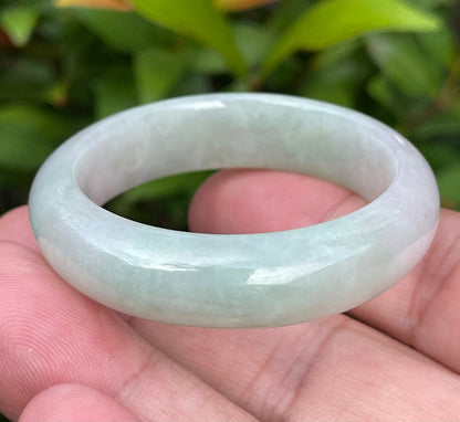 Handcrafted genuine Grade A Burmese jadeite infant bangle showcasing translucent multi-colored hues