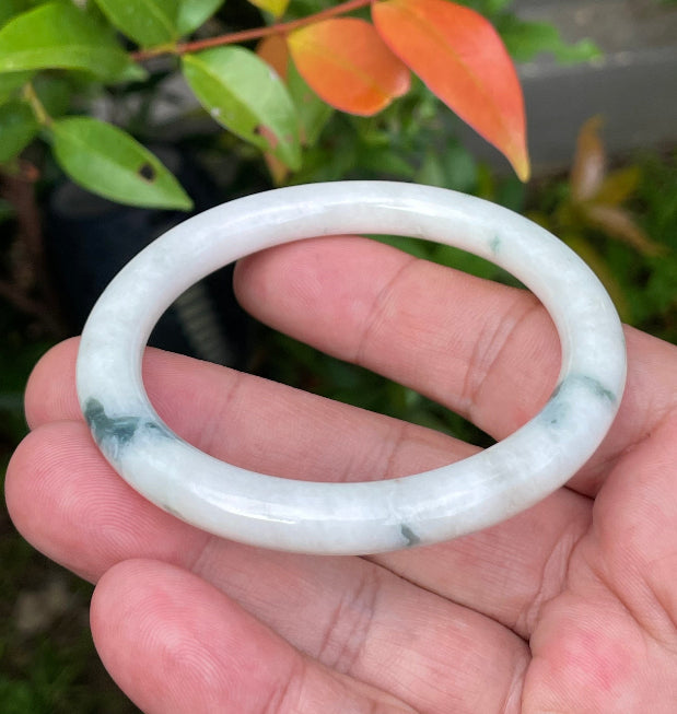 Handcrafted genuine Grade A Burmese jadeite bracelet showcasing a beautiful green and white appearance