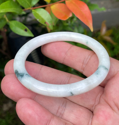 Handcrafted genuine Grade A Burmese jadeite bracelet showcasing a beautiful green and white appearance