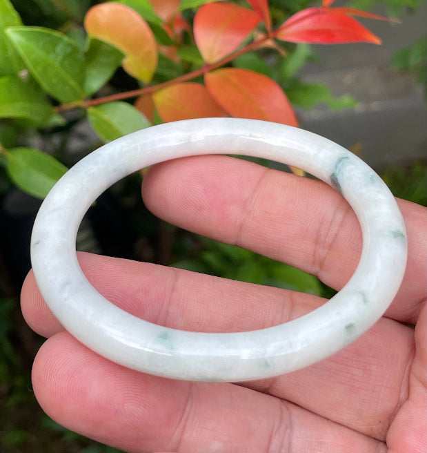 Handcrafted genuine Grade A Burmese jadeite bracelet showcasing a beautiful green and white appearance