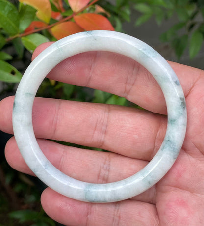 Handcrafted genuine Grade A Burmese jadeite bracelet showcasing a beautiful green and white appearance