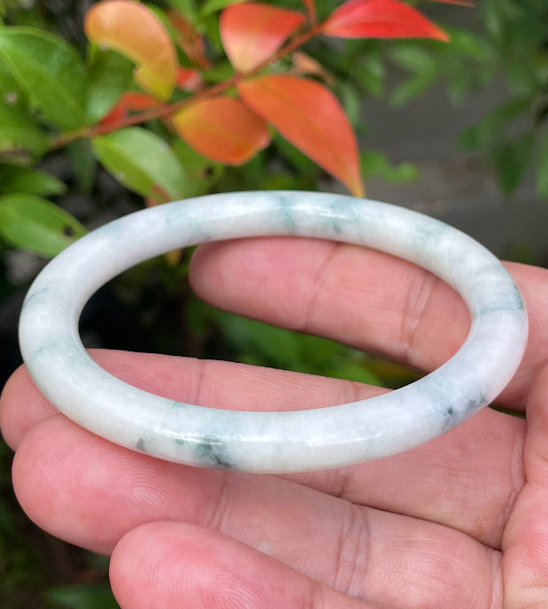 Handcrafted genuine Grade A Burmese jadeite bracelet showcasing a beautiful green and white appearance