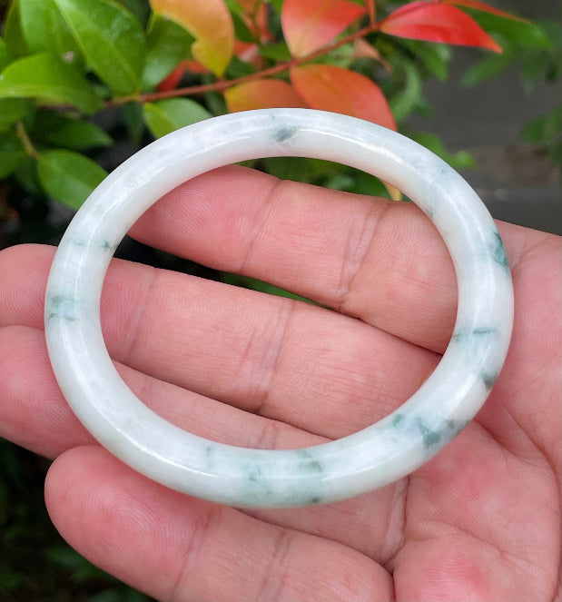 Handcrafted genuine Grade A Burmese jadeite bracelet showcasing a beautiful green and white appearance