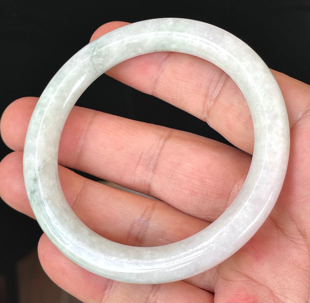 Handcrafted genuine Grade A Burmese jadeite bracelet showcasing a beautiful green and white appearance