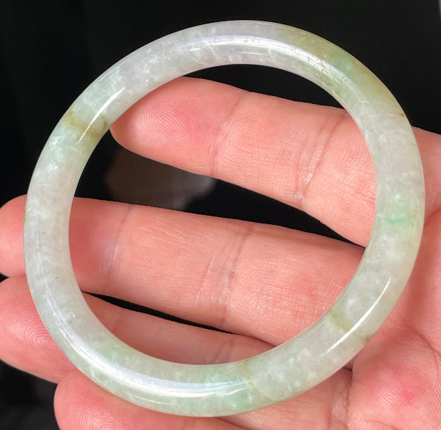 Handcrafted genuine Grade A Burmese jadeite bracelet showcasing a beautiful green and white appearance
