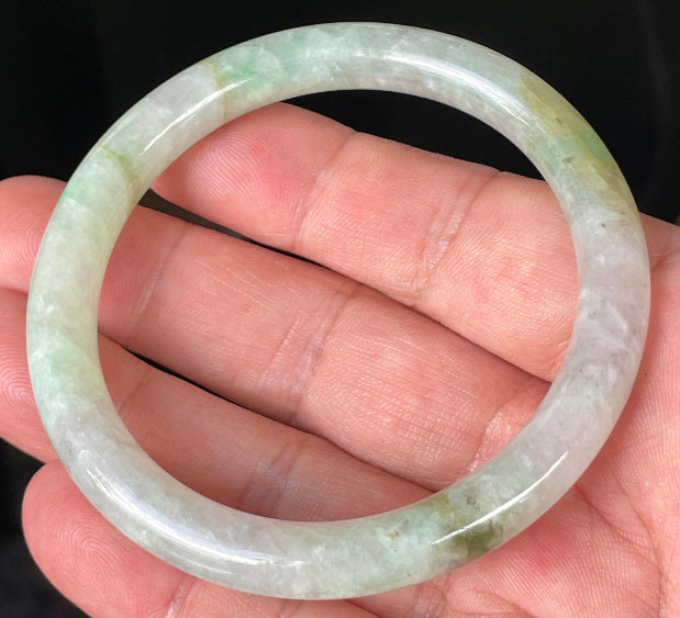 Handcrafted genuine Grade A Burmese jadeite bracelet showcasing a beautiful green and white appearance