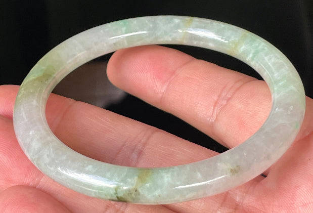Handcrafted genuine Grade A Burmese jadeite bracelet showcasing a beautiful green and white appearance