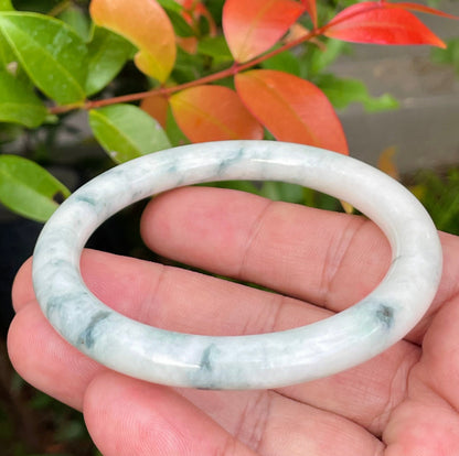 Handcrafted genuine Grade A Burmese jadeite bracelet showcasing a beautiful leafy green and white appearance