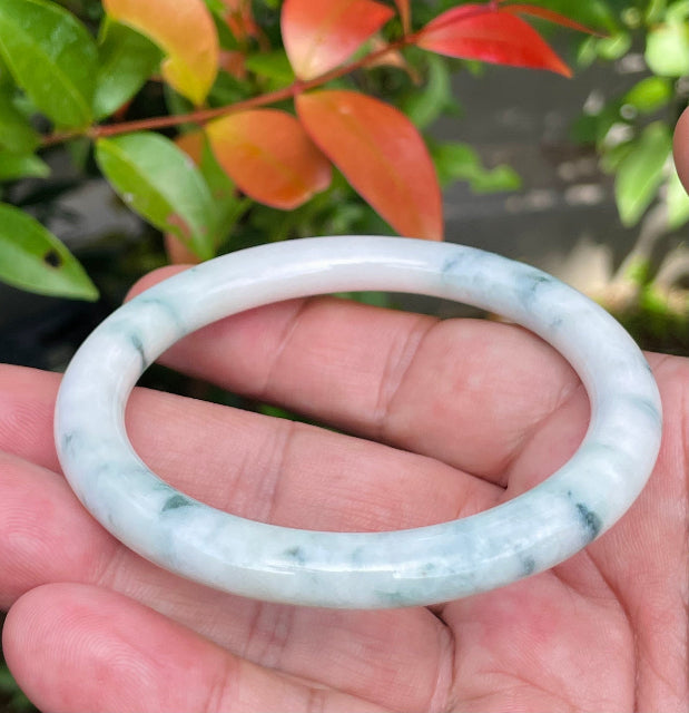 Handcrafted genuine Grade A Burmese jadeite bracelet showcasing a beautiful serene white and green appearance