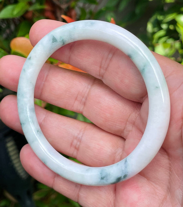 Handcrafted genuine Grade A Burmese jadeite bracelet showcasing a beautiful serene white and green appearance