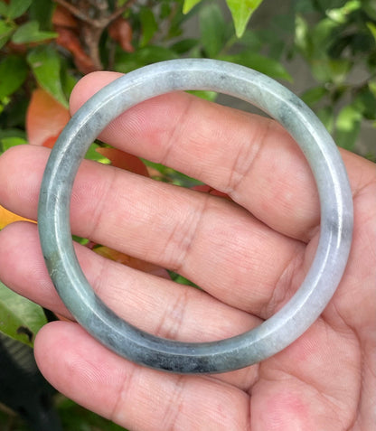 Handcrafted genuine Grade A Burmese jadeite bracelet showcasing a beautiful rare moss green, black, and white appearance