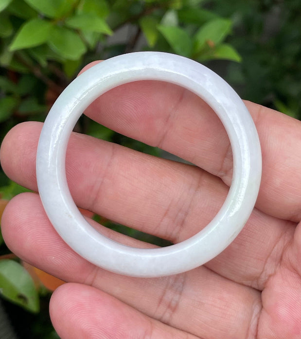 Close-up of a 41.2mm infant natural Grade A Burmese jadeite bangle featuring icy milky white, lavender, and apple green hues, item JB889