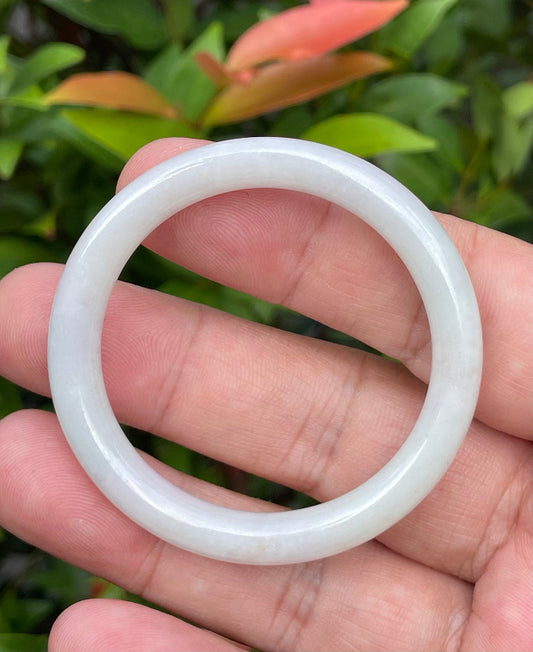 Close-up of a 42.5mm infant natural Grade A Burmese jadeite bangle featuring icy milky white, lavender, and apple green hues, item JB886