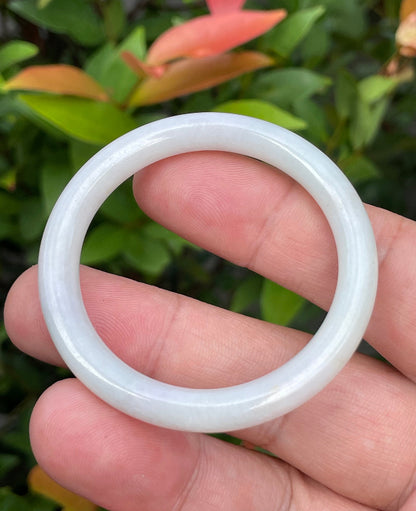 Handcrafted genuine Grade A Burmese jadeite infant bangle showcasing translucent multi-colored hues