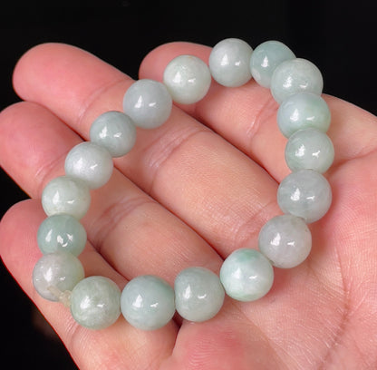 Handcrafted genuine Grade A Burmese jadeite stretch bracelet showcasing beautiful bluish apple green and milky white round beads