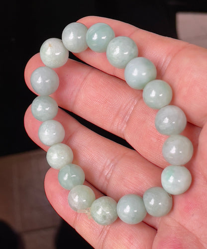 Handcrafted genuine Grade A Burmese jadeite stretch bracelet showcasing beautiful bluish apple green and milky white round beads
