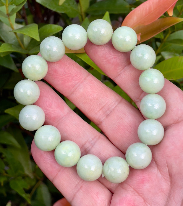 Handcrafted genuine Grade A Burmese jadeite stretch bracelet with large 13.4mm beads in a luminous mix of green and milky white shades