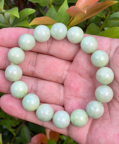 Handcrafted genuine Grade A Burmese jadeite stretch bracelet with large 13.4mm beads in a luminous mix of green and milky white shades
