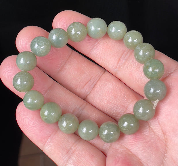 Handcrafted genuine Grade A Burmese jadeite stretch bracelet showcasing beautiful icy apple green round beads