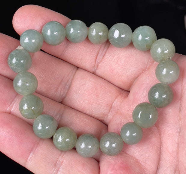 Handcrafted genuine Grade A Burmese jadeite stretch bracelet showcasing beautiful icy apple green round beads
