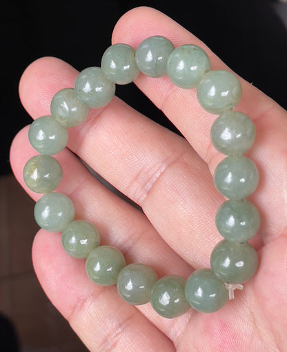 Handcrafted genuine Grade A Burmese jadeite stretch bracelet showcasing beautiful icy apple green round beads