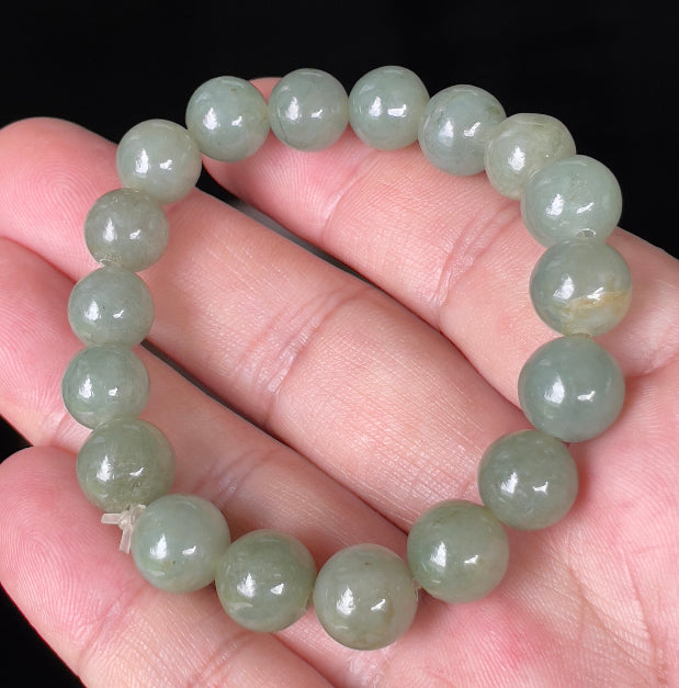 Handcrafted genuine Grade A Burmese jadeite stretch bracelet showcasing beautiful icy apple green round beads