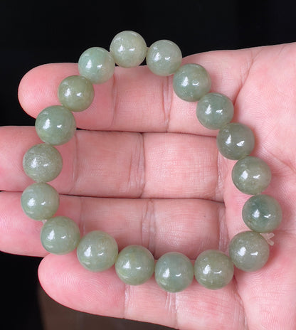 Handcrafted genuine Grade A Burmese jadeite stretch bracelet showcasing beautiful icy apple green round beads