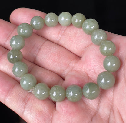 Handcrafted genuine Grade A Burmese jadeite stretch bracelet showcasing beautiful icy apple green round beads