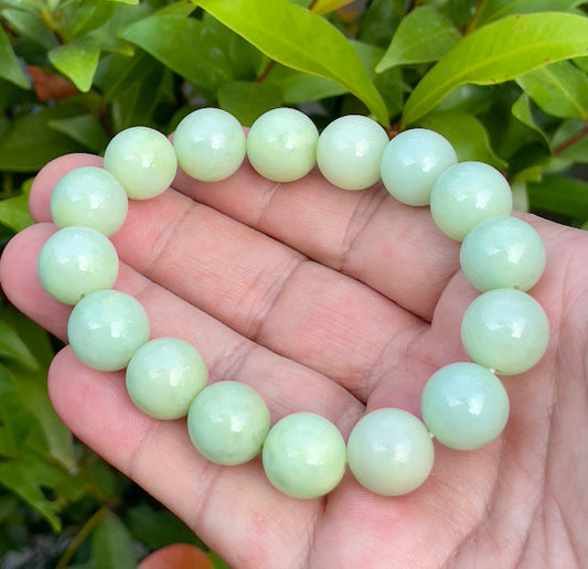 Close-up of a 13.4mm natural Grade A Burmese jadeite beaded bracelet featuring icy apple green, forest green, and milky white beads, item JBB172