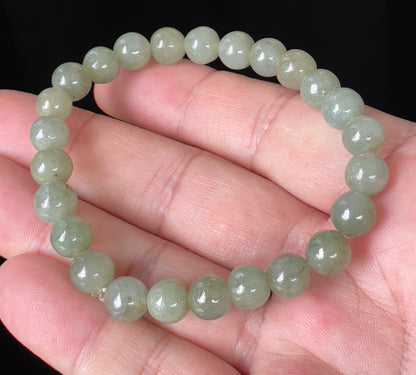 Handcrafted genuine Grade A Burmese jadeite stretch bracelet showcasing beautiful apple green beads