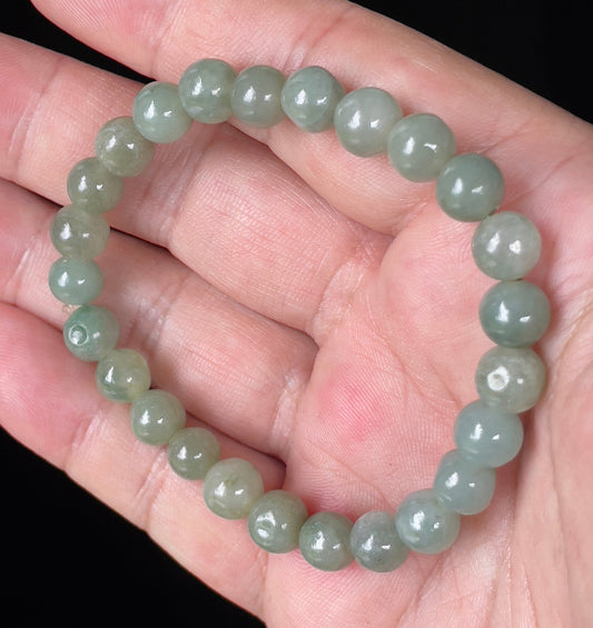 Close-up of an 8mm natural Grade A Burmese jadeite beaded bracelet featuring hand-shaped icy apple green beads, item JBB127