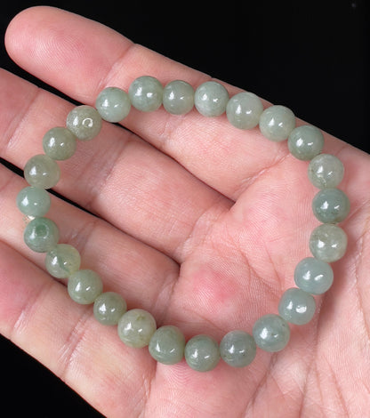Handcrafted genuine Grade A Burmese jadeite stretch bracelet showcasing beautiful icy apple green round beads