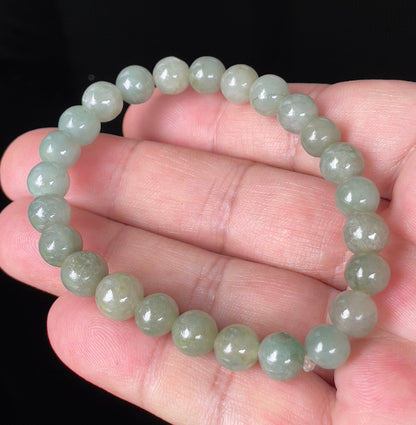 Handcrafted genuine Grade A Burmese jadeite stretch bracelet showcasing beautiful icy apple green round beads