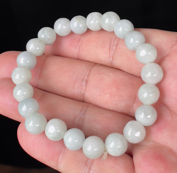 Close-up of a 9.7mm natural Grade A Burmese jadeite beaded bracelet featuring hand-shaped icy apple green and milky white beads, item JBB134