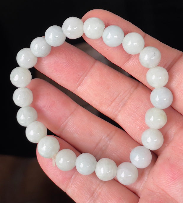 Handcrafted genuine Grade A Burmese jadeite stretch bracelet showcasing beautiful icy apple green and milky white round beads
