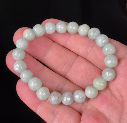 Close-up of a 9.5mm natural Grade A Burmese jadeite beaded bracelet featuring hand-shaped icy apple green and milky white beads, item JBB135