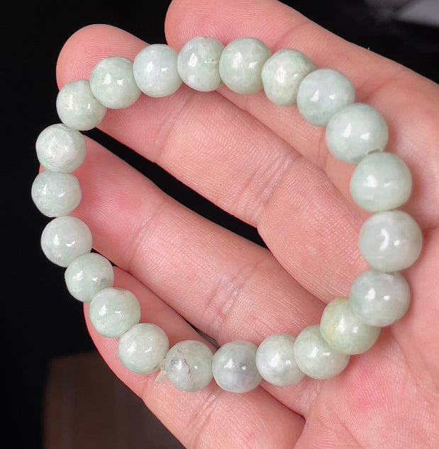 Handcrafted genuine Grade A Burmese jadeite stretch bracelet showcasing beautiful icy apple green and white round beads