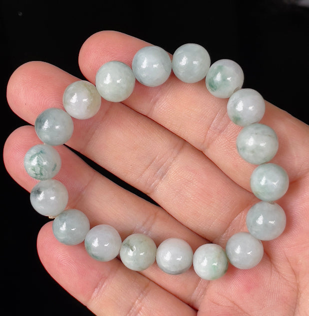 Close-up of a 10.4mm natural Grade A Burmese jadeite beaded bracelet featuring hand-shaped icy apple and imperial green beads, item JBB139