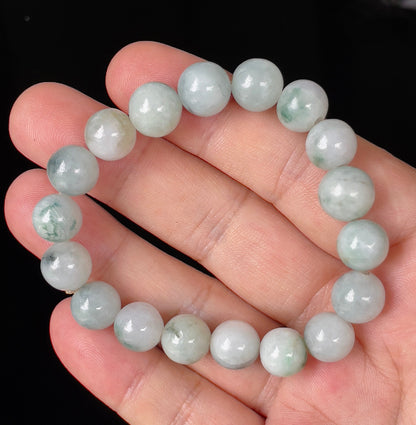 Close-up of a 10.4mm natural Grade A Burmese jadeite beaded bracelet featuring hand-shaped icy apple and imperial green beads, item JBB139