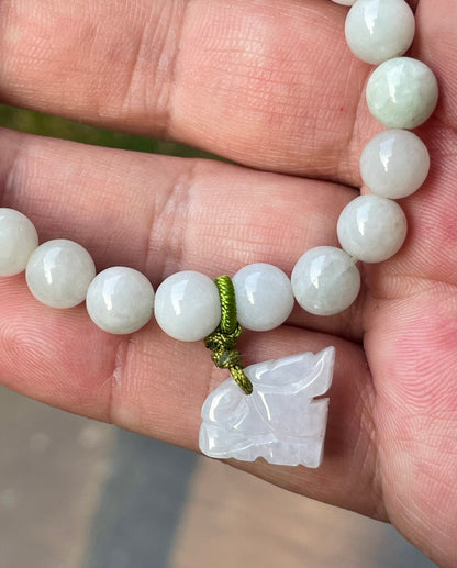 Handcrafted genuine Grade A Burmese jadeite stretch bracelet showcasing beautiful milky white and icy apple green beads with a hand-carved tiger pendant