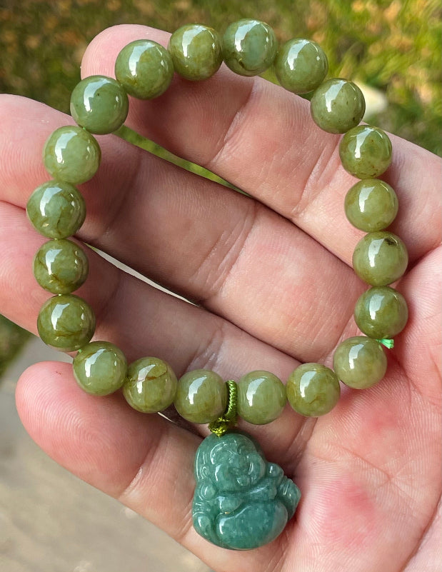 Handcrafted genuine Grade A Burmese jadeite stretch bracelet showcasing beautiful olive green beads with a hand-carved Laughing Buddha pendant